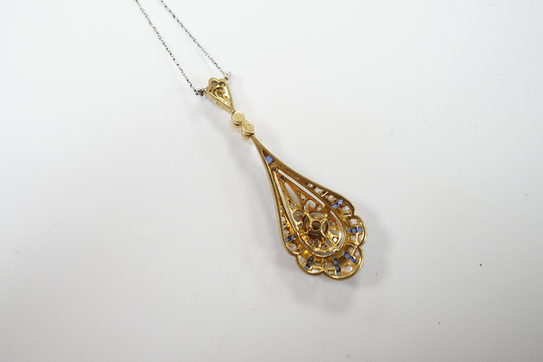A Belle Époque pierced yellow metal, sapphire, diamond and seed pearl set pendant necklace, overall 50cm, gross weight 4.3 grams. Fair condition.